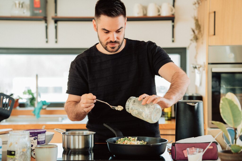 a bearded man cooking at home