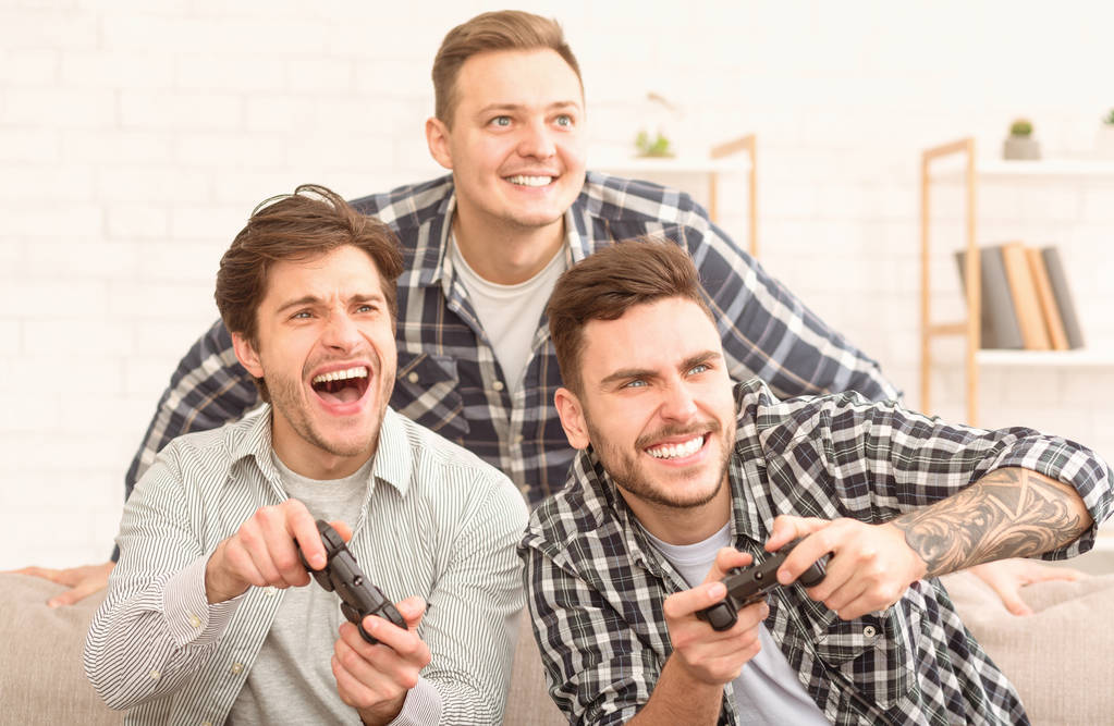 Excited men playing video game